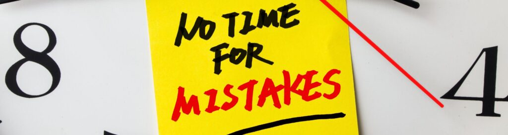 Photo of a note with the text "No time for Mistakes" on a clock