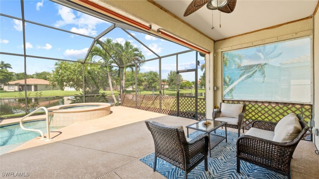 Photo of the lakefront pool and spa and screened lanai perfect for enjoying the beautiful Florida sunsets.